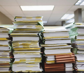 Piles of files and documents on a desk