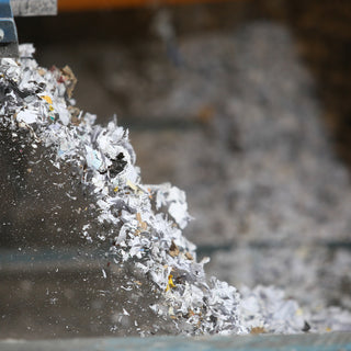 paper being shredded through industrial shredding service.